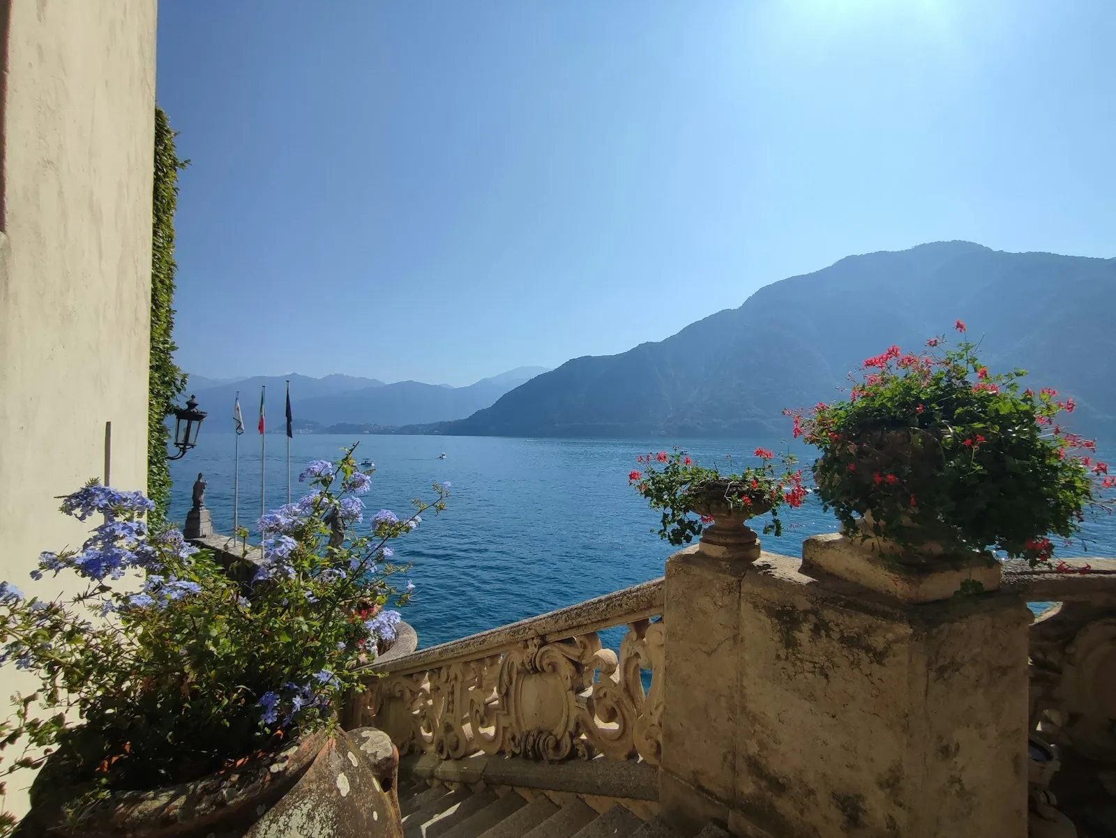 Balcone fiorito con vista sul lago e sulle montagne